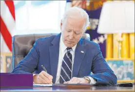  ?? Andrew Harnik The Associated Press ?? President Joe Biden signs the American Rescue Plan, a coronaviru­s relief package, Thursday in the Oval Office of the White House.