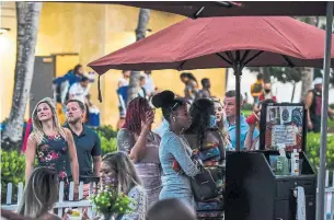  ?? CHANDAN KHANNA AFP VIA GETTY IMAGES ?? People wait for a table in Miami Beach, Fla., on Friday. The CDC found that in South Florida, two per cent of the population was exposed to the virus as of April 10, but it’s likely to be higher now.