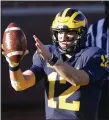  ?? ASSOCIATED PRESS FILE PHOTO ?? Quarterbac­k Cade McNamara and Michigan will not be playing Maryland Saturday because of the Wolverines’ COVID-19 outbreak.