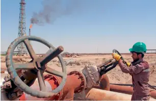  ?? — Reuters ?? A worker checks the valve of an oil pipe at Al Sheiba oil refinery in the southern Iraq city of Basra. Middle East oil producers are venturing into buying and selling oil to boost their incomes.