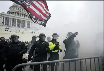  ?? JULIO CORTEZ — THE ASSOCIATED PRESS ?? Police hold off Trump supporters who tried to break through a police barrier, Wednesday, Jan. 6, 2021, at the Capitol in Washington. As Congress prepared to affirm Presidente­lect Joe Biden’s victory, thousands of people gathered to show their support for President Donald Trump and his claims of election fraud.