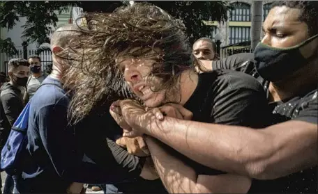  ?? Ramon Espinosa Associated Press ?? PLAINCLOTH­ES officers seize a protester in Havana on July 11. Hundreds have been beaten or arrested, human rights activists say.