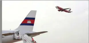  ?? HENG CHIVOAN ?? A plane takes off from Phnom Penh Internatio­nal Airport in 2013.