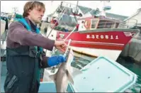  ?? PHOTOS BY LOIC VENANCE / AFP ?? French fisherman Daniel Kerdavid killing a shark according to the Japanese technique