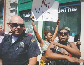  ?? BRYAN WOOLSTON / REUTERS ?? Ohio residents display their displeasur­e at the visit Wednesday by U.S. President Donald Trump near the site of last
Sunday’s mass shooting in Dayton. Trump was met with similar protests later in the day in El Paso, Texas.