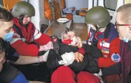  ?? EVGENIY MALOLETKA AP FILE ?? Paramedics move a civilian wounded in shelling onto a stretcher to be taken to a maternity hospital converted into a medical ward in Mariupol, Ukraine.