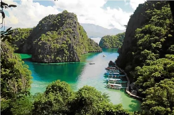  ?? —LOUISE SANTIANO ?? Coron Island Cove viewed from a ridge, often seen in postcards and travel magazines