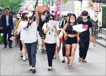  ?? YEON-JE/AFP JUNG ?? This picture taken on August 18 shows South Korean women participat­ing in a protest to urge tech giants including Google, Youtube, Facebook and Twitter to work harder to curb high-tech sex crimes in Seoul.