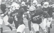  ?? SHAWN MCFARLAND/COURANT FILE PHOTO ?? Maloney senior James Tarver outruns a defender. Maloney and Platt High played an 11-on-11 football game against each other on Saturday, operating independen­tly from their schools. Platt played as the Westsiders, and Maloney played as the Eastsiders.