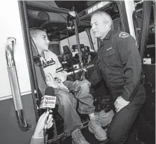  ?? Tony Gutierrez / Associated Press file photo ?? In 2012, Koregan Quintanill­a, then 10, meets firefighte­r Wesley Keck, who found him left outside an Arlington fire station.