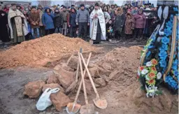  ?? EMILIO MORENATTI/AP ?? Friends and relatives mourn at the funeral Monday of Oleksandr Maksymenko, in his home village of Kniazhychi, east of Kyiv. Oleksandr, a civilian who was a volunteer in the armed forces of Ukraine, was killed in combat.
