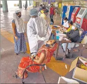  ??  ?? A medic takes a swab sample from a commuter for Covid-19 testing in Navi Mumbai on Monday