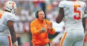  ?? THE ASSOCIATED PRESS ?? Tennessee coach Butch Jones encourages his players as they run off the field during the first half Saturday.