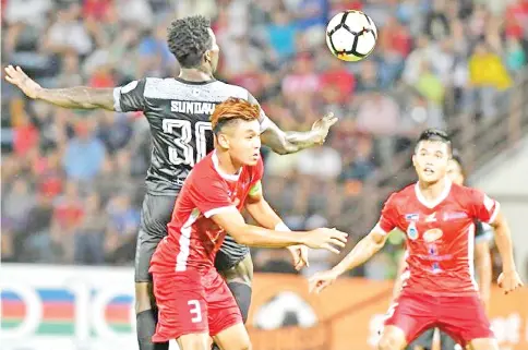  ?? Courtesy of Jaiman Taip — Photo ?? Skipper Rawilson Batuil who scored twice in Sabah's 4-0 win at the Likas Stadium on Friday night is seen challengin­g an import striker in the match against Terengganu FC II.