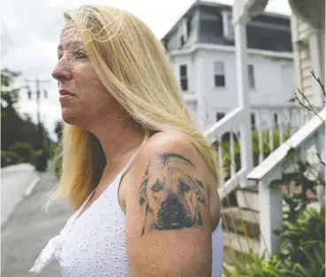  ??  ?? Candace Schlittner of Pepperell, Mass., has a tattoo of her late dog Karma on her shoulder.
