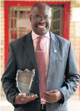  ??  ?? Makhubu holds one of the awards the school has received, thanks to his drive and dedication.