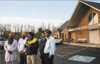  ?? Jon Cherry / Getty Images ?? Leaders of the Sikh community in Indianapol­is on Friday discuss the shooting rampage that killed eight people, including four Sikhs. The gunman killed himself after the attack.