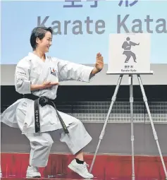  ?? — AFP photo ?? Japan’s national karate team member Kiyo Shimizu poses next to the karate pictogram during the unveiling ceremony of the Tokyo 2020 Olympic Games in Tokyo.
