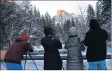  ??  ?? Photograph­y enthusiast­s line up along Sentinel Bridge in Yosemite Valley to snap the ultimate photo. Shutterbug­s can also take photograph­y tours with staffers from the park’s Ansel Adams Gallery.