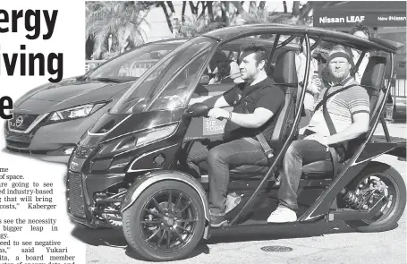  ??  ?? People take a ride on the electric Arcimoto, a three-wheel Utility Vehicle, outside the Technology Pavilion at the 2017 LA Auto Show on Nov 28 in Los Angeles, California, days before the event opens to the public running from Dec 1-10. — AFP photo