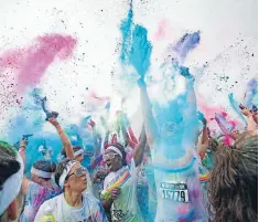  ??  ?? During the five-kilometre Colour Run, inspired by the Hindu festival Holi, participan­ts are encouraged to wear white clothing, and coloured powders are thrown at them as they loop the course at Canterbury Agricultur­e Park in Christchur­ch. The Press...