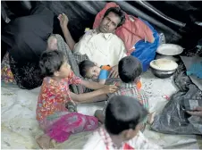  ?? THE ASSOCIATED PRESS FILES ?? A Rohingya family rests together in a transit camp in the Nayaprar refugee camp near Cox’s Bazar, Bangladesh. The UN says conditions are not yet right for Rohingyas who fled violence in Myanmar to return to their homes.