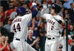  ??  ?? Alex Bregman celebrates with Yordan Alvarez in the fourth inning after hitting his 31st home run, tying a career high.