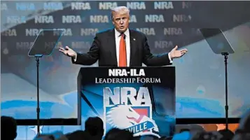  ?? MARK CORNELISON/THE LEXINGTON HERALD-LEADER ?? Then-candidate Donald Trump speaks at a National Rifle Associatio­n forum in May of 2016, where he found many fans.
