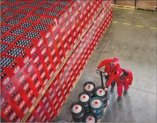  ??  ?? Warehouse workers move product at the Csiki Sor brewery. Heineken’s claim that the small Transylvan­ian brewery’s beer was named too similarly to one of its offerings didn’t sit well with the smaller brewery’s customers or the government in neighborin­g...