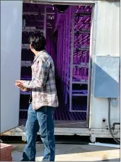  ?? ?? SHS senior Job Bejarano talks to people about the CROPBOX - the school’s controlled environmen­t agricultur­e system which helps crops grow only with water and artificial light.