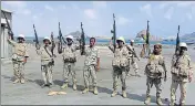  ??  ?? Army soldiers hold up their weapons after taking over the main port of Yemen's city of Aden from gunmen in January 2016. REUTERS FILE