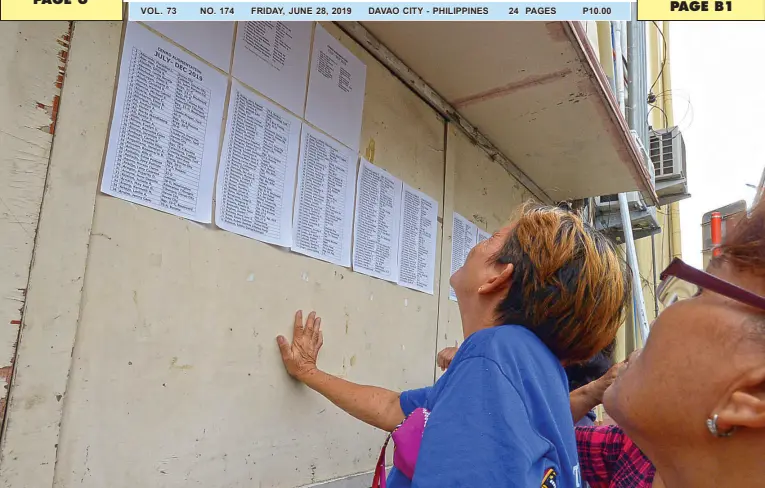  ??  ?? APPLICANTS search for their names in the list of hired workers assigned at the City Environmen­t and Natural Resources Office in a memo posted outside City Hall. BING GONZALES