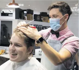  ?? Photo / Brett Phibbs ?? Corbin Harkness, 17, was the first to get a haircut at 12.01am yesterday at BarberShop­Co.