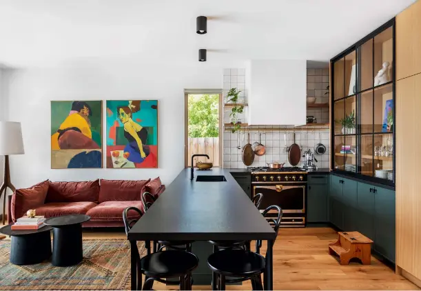  ??  ?? ABOVE: The kitchen’s long counter serves as a prep area and dining table. Counter, Dekton; backsplash by Wow, Tierra Sol Ceramic Tile.