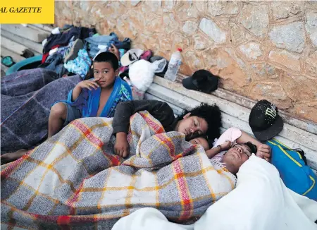  ?? FELIX MARQUEZ / THE ASSOCIATED PRESS ?? A boy sits awake as Central American migrants, travelling with the annual “Stations of the Cross” caravan, sleep at a sports club in Oaxaca, Mexico, on Tuesday. The caravan angered U.S. President Donald Trump, despite being sidelined in southern Mexico...