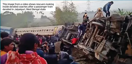  ?? ?? This image from a video shows rescuers looking inside derailed coaches after a passenger train derailed in Jalpaiguri, West Bengal state