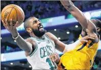  ?? AP PHOTO ?? Boston Celtics point guard Kyrie Irving, left, shoots against Utah Jazz’s Ekpe Udoh during a Dec. 15 NBA game in Boston.