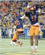  ?? [AP PHOTO] ?? Syracuse’s Trishton Jackson, left, celebrates his touchdown catch with teammate Jamal Custis during the second half of the Camping World Bowl on Friday night against West Virginia.
