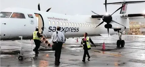  ?? NICHOLAS RAMA (ANA) ?? A PASSENGER boards an SA Express jet at OR Tambo Internatio­nal Airport. The entity is to merge with SAA and Mango to curtail management costs.