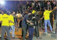  ?? AFP ?? Police try to keep order during New Year’s Eve celebratio­ns in Bangalore last week.