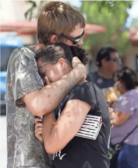  ??  ?? Kendall Long, left, comforts Kianna Long, who was in the freezer section of a Walmart during a shooting Saturday in El Paso, Texas.