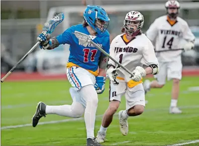  ?? SARAH GORDON/THE DAY ?? In this April 23, 2019, file photo, Waterford’s Kyle Jacobson, left, moves past East Lyme’s Richie Galbo during a boys’ lacrosse game. Jacobson will spend a year at Naval Academy Prep this year, then will play lacrosse at the Coast Guard Academy.