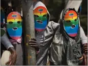  ?? BEN CURTIS — THE ASSOCIATED PRESS FILE ?? Kenyan gays and lesbians and others supporting their cause wear masks to preserve their anonymity as they stage a rare protest against Uganda's tough stance against homosexual­ity in 2014.