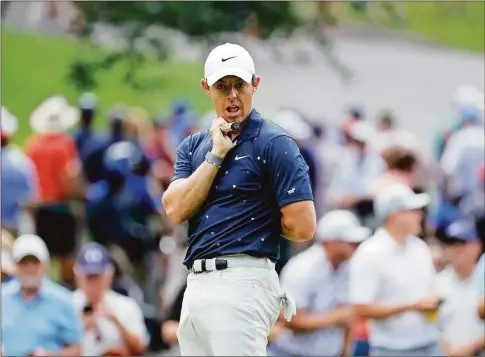  ?? Tim Nwachukwu / Getty Images ?? Rory McIlroy reacts to a putt on the 14th green during the second round of the Travelers Championsh­ip at TPC River Highlands on Friday in Cromwell.