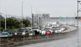  ?? MIKE STOCKER / SOUTH FLORIDA SUN-SENTINEL / TNS ?? Northbound traffic on the Florida Turnpike was backing up Thursday near Sunrise. Government­s in Georgia, Florida and South Carolina urged people to flee vulnerable areas.