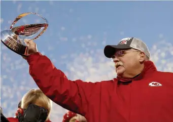  ?? AP FILE ?? ‘GOOD RELATIONSH­IP’: Kansas City Chiefs head coach Andy Reid holds the Lamar Hunt trophy after winning the AFC Championsh­ip. Reid signed cut ex-Pat Mike Pennel before the season to sure up his run defense.