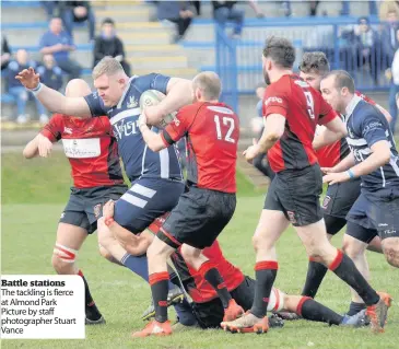  ??  ?? Battle stations The tackling is fierce at Almond Park Picture by staff photograph­er Stuart Vance