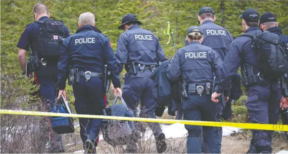  ?? AL CHAREST/FILES ?? Calgary police investigat­e after finding the bodies believed to be Jasmine Lovett and her 22-month-old daughter, Aliyah Sanderson, in the woods off Hwy 40 in Kananaskis Country, between the Centex gas station and Grizzly Creek day use area on Monday, May 6, 2019.