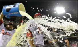  ?? DERIK HAMILTON — THE ASSOCIATED PRESS ?? The Phillies’ Ty Kelly, center, is doused by Andres Blanco, left, following the 1-0 win over the Boston Red Sox Thursday in Philadelph­ia.