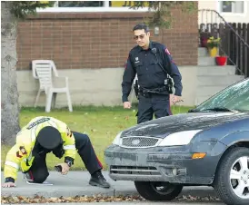  ?? JIM WELLS ?? Calgary police investigat­e at the scene of a deadly accident on Friday.